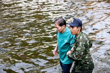 Bangkok, Thailand - November 5, 2011: The Soldier help Old Man for travel.のeditorial素材