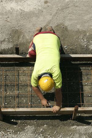 A worker laying securing mesh before cementingの写真素材