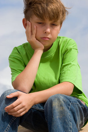 Unhappy, lonely or sulky child.の写真素材