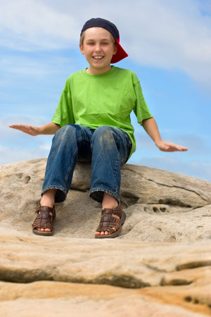 A child outdoors having fun with happy expression.  Movement in arms.の写真素材