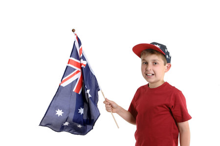 Young boy proudly holding an Australian flag in his hand.の写真素材