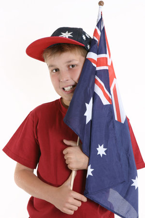 A young boy casually holds an Australian flagの写真素材