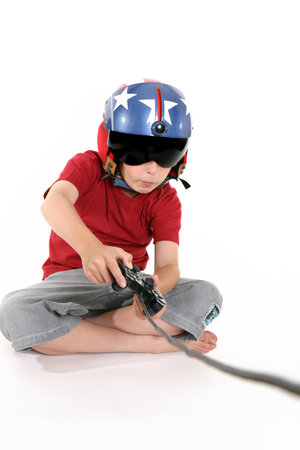 An attentive child engrossed playing a flight simulator gameの写真素材