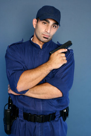 Security officer in uniform holding gun.