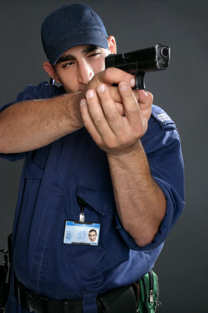 Security officer takes aim with his gun.  Please note:  Badge photo is same person and was...
