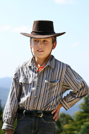 Country boy in highland countryside wearing a hat to shield the sun     200isoの写真素材