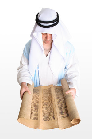 A mean reading from a section of bible scroll - Exodus/Shemot.    The manuscript is written on...