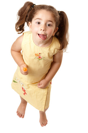 Above view of a young girl child standing  and licking her lips.   の写真素材