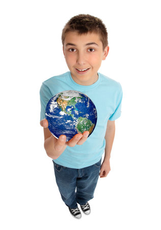 A boy in casual jeans and t-shirt holding with care our beautiful planet earth in his hand.の写真素材