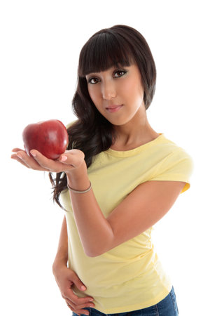 A young woman holding a piece of fruit in the palm of her hand.の写真素材
