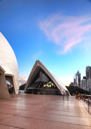 Sydney, Australia - December 2, 2013; Pretty pink clouds in the shape of its sails hang over the Guillaume at Benelong restaurant, Opera House Sydney, Concert Hall to left.のeditorial素材