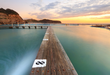 North Narrabeen Tidal Pool from Lane 8, Narrabeen Beach Sydney, Australia, at sunrise. Focus to foregroundの写真素材