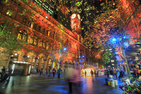 SYDNEY, AUSTRALIA - JUNE 6, 2014;   Martin Place, A CBD and shopping disrict of Sydney lit up in various ever changing colour, during annual Vivid festival   People in motion   Sky flower in distance のeditorial素材