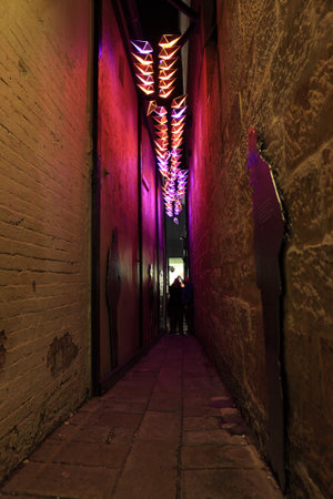SYDNEY, AUSTRALIA - JUNE 6, 2014;  Clapiconia light installation in a narrow alleyway in The Rocks precinct during Vivid Sydney annual festival event.  The lights react and change colour to participants clapping sounds のeditorial素材