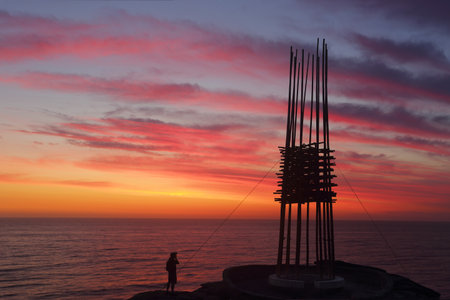 BONDI, AUSTRALIA - 23 OCTOBER, 2014; Sculpture by the Sea Annual Festival Event 2014.  Sculpture titled Save Our Souls by Cave Urban, NSW.  Silhouette against a sunrise sky. Materials, bamboo, rope,  steel, LED lights.   Price $30000のeditorial素材