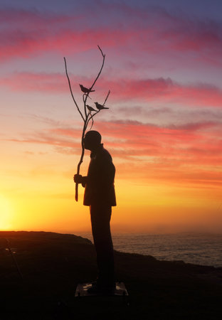 BONDI, AUSTRALIA - OCTOBER 23, 2014; Sculpture by the Sea Annual free public event 2014.  Exhibit titled Man playing with Birds  by artist Wang Shugang, China,  Materials, stainless steel, titanium, Price $120000のeditorial素材