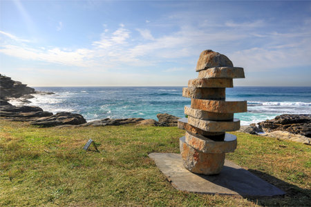 BONDI, AUSTRALIA - OCTOBER 23, 2014; Sculpture by the Sea Annual free public event 2014.  Exhibit titled  The Figure in the Landscape  by artist John Petrie NSW.  Materials,  basaltのeditorial素材