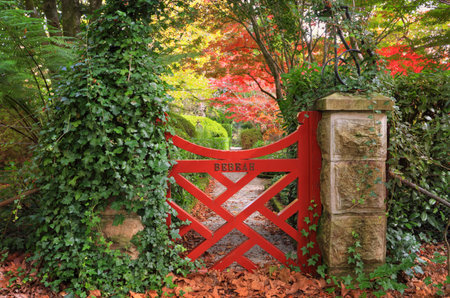 The little red gate at Bebeah Gardens in Autumn.  The parklands were originally built by Edward Cox in 1880.  Sprawling over 5 acres the garden includes various vistas of formal country garden with a grand sense of design. Bebeah is an open garden best viの写真素材
