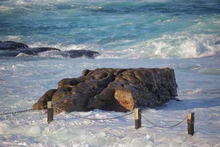 Mahon rockpool at Maroubra swallowed up in whitewater from surging  tide in rough weather.