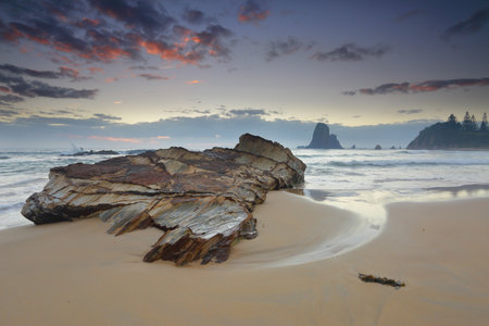 Windy morning along the Narooma cloastline.  In the foreground, one of the many rock formations around here at Glasshouse Rocks.の写真素材