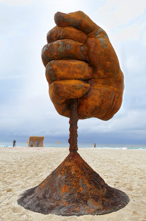 BONDI, AUSTRALIA - OCTOBER 22, 2015;  Annual Sculpture by the Sea free public event.  Exhibit titled  Dust by Norton Flavel.  Weathered steel fist.のeditorial素材
