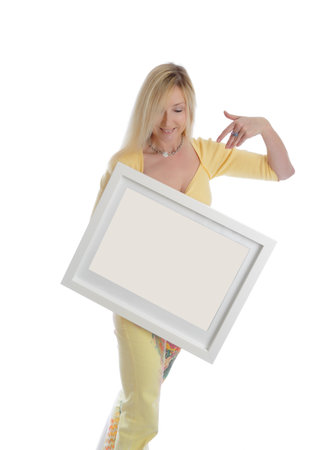 Smiling woman holding a blank picture white box frame and smiling.  Just add your own picture, painting or message,のeditorial素材