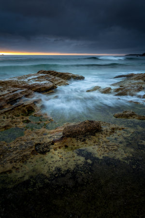 Moody morning with rain and sunshine at Cronulla Beachの写真素材
