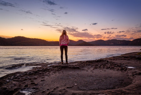 Watching the sunset from the foreshore of Peat Island, Australiaの写真素材