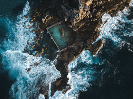 Curl Curl Ocean Rock Pool built into the side of a cliff aerial viewの写真素材
