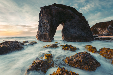 Ocean waves flow around coastal formation  Horse Head Rock Australiaの写真素材