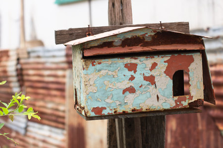 Rusty old mailbox not in use, but is still placed at front of the house entrance.の写真素材