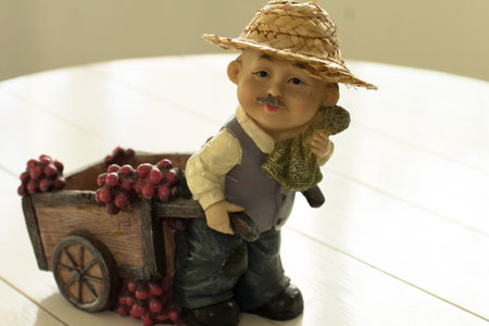 A French gentleman is pulling a wooden cart to the vineyard to collect fresh grapes.の写真素材
