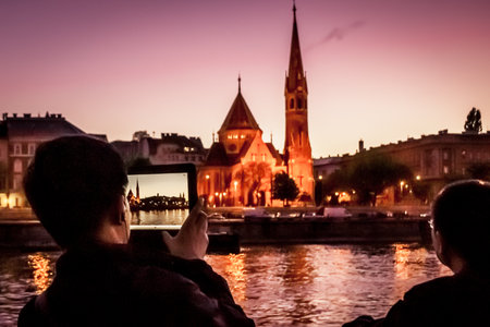 Tourist takes a photo with an tablet about a churchのeditorial素材
