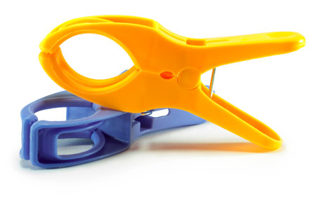 Isolated blue and yellow plastic clamps on white backgroundの写真素材