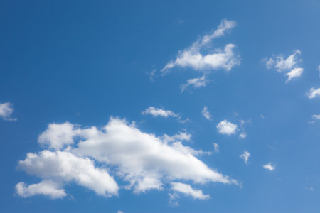 A photo of a blue sky with a few white cloudsの写真素材