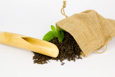 bamboo scoop and chinese tea leaves in sackclothの写真素材