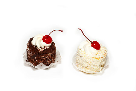 Two sweet and nourishing cake with cherryの写真素材