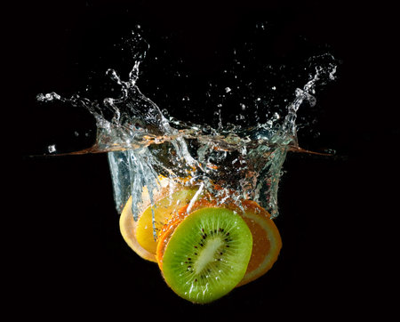 Tropical fruits fall underwater with a big splashの写真素材