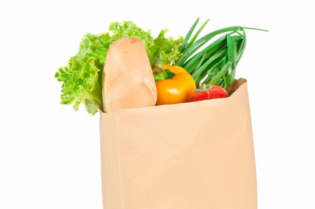 Fresh healthy groceries in a paper bag isolated on white backgroundの写真素材