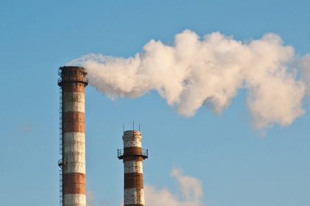 Two pipes and smoke on blue sky backgroundの写真素材