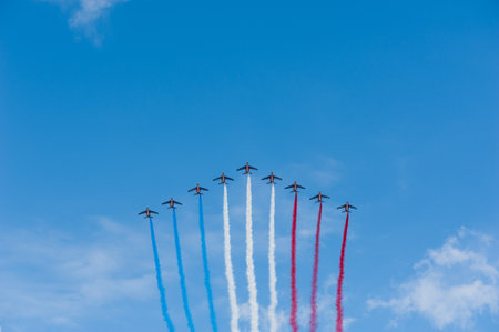 Paris, France - July 14th, 2011: French Air Patrol flying in a blue sky with blue, white and red vapor trails for the French National Day.のeditorial素材