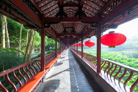 Culture Park, Chengdu, Sichuan Province, China - July 16, 2015: People doing sport on a traditional bridge with chinese lanterns in a sunny morning.のeditorial素材
