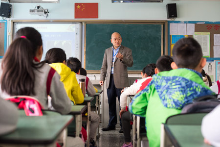 Chengdu, Sichuan Province, China - March 31, 2017: Teacher giving a lesson to children in a chinese classroomのeditorial素材