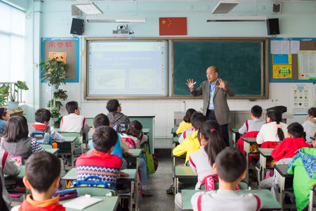 Chengdu, Sichuan Province, China - March 31, 2017: Teacher giving a lesson to children in a chinese classroomのeditorial素材