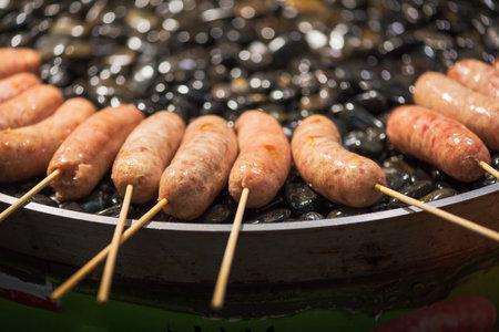 barbecue of sausages on stones - chinese street foodの写真素材