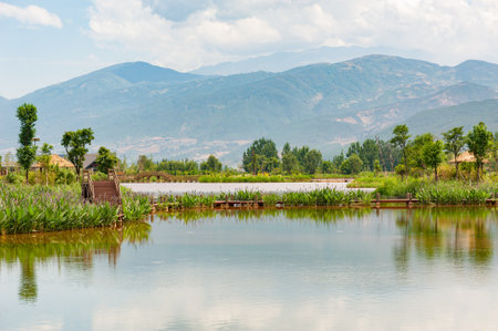 Lake and wood bridges with mountains in the backgroundの写真素材