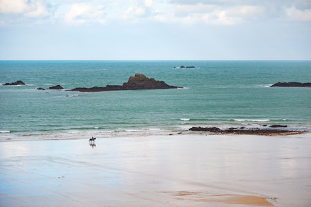 A man and a horse on an empty beachの写真素材