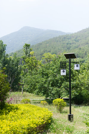 Lamppost powered by a solar panel in a mountain park