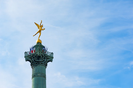 Bastille column with french flags against blue sky in Parisの写真素材