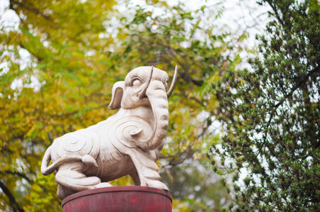 White elephant statue against trees in Chinaの写真素材